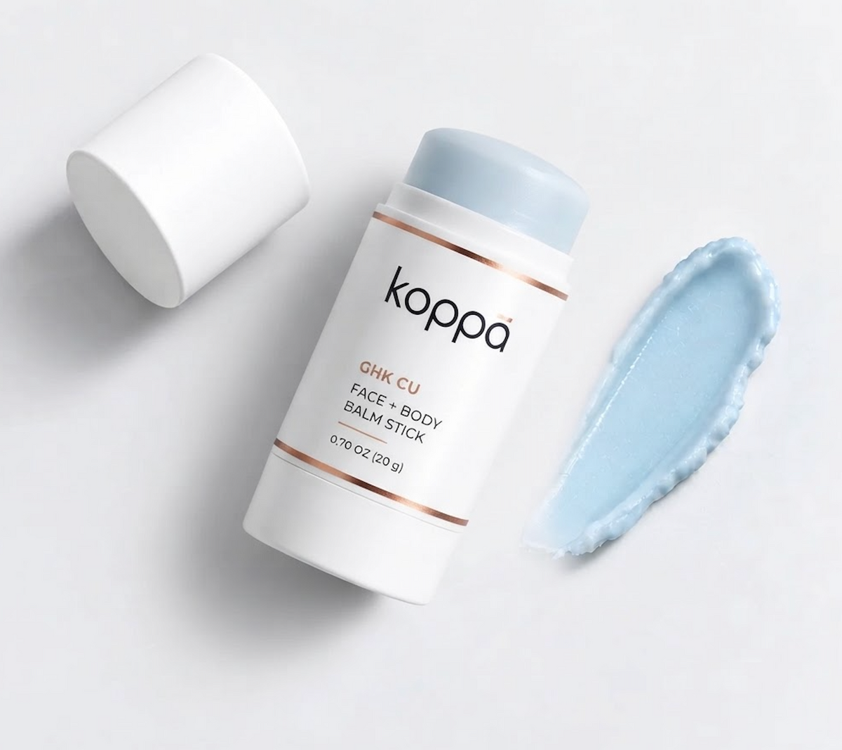 Uncapped Koppā GHK-Cu Face + Body Balm Stick with a pale blue balm tip, cap and texture swatch