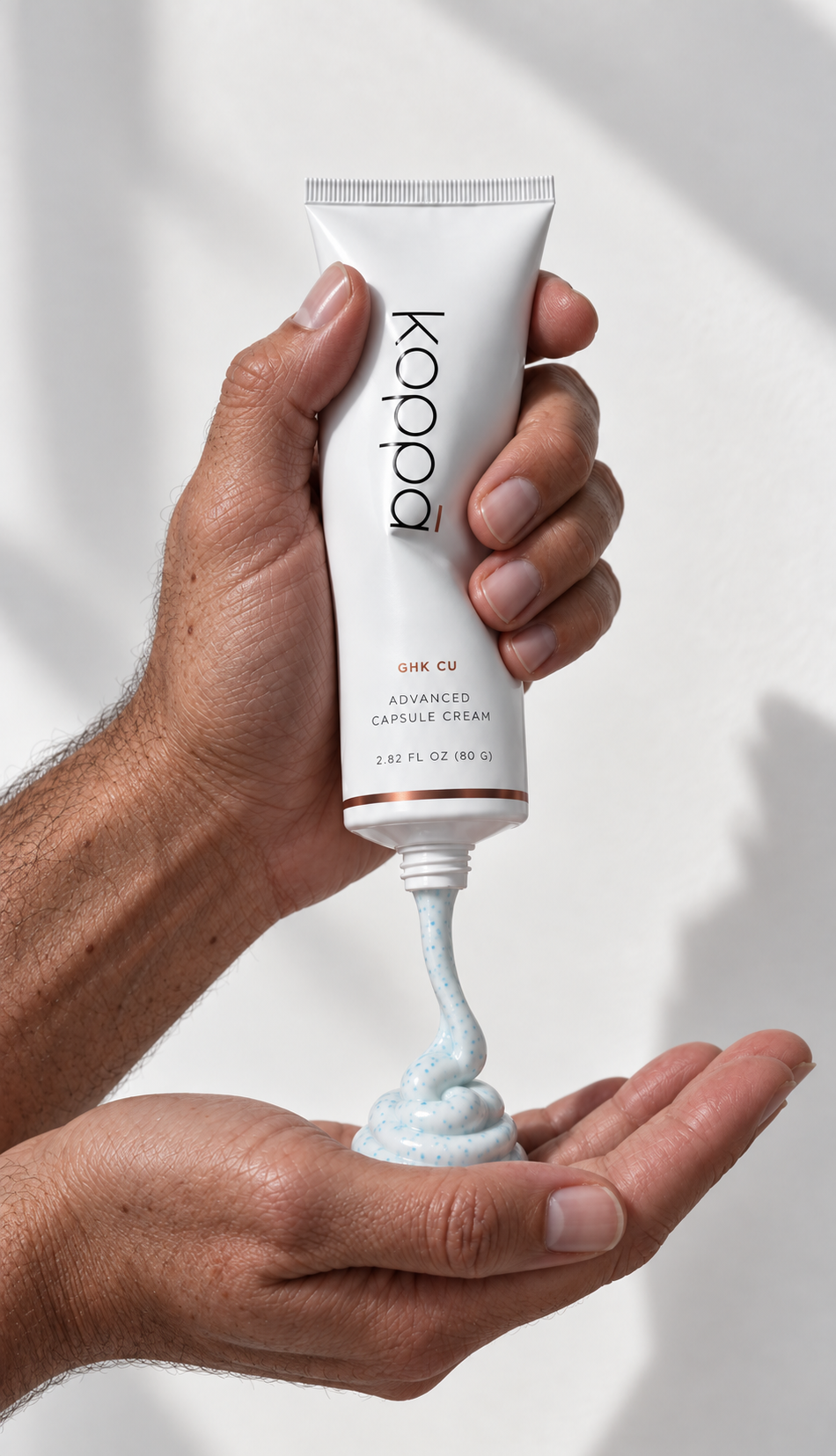 Man dispensing Koppā GHK-Cu Advanced Capsule Cream into his hand