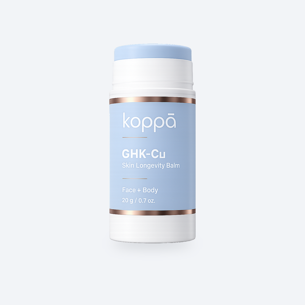 Koppā GHK-Cu Skin Longevity Balm stick on a soft porcelain background