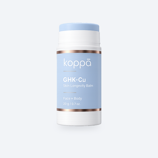 Koppā GHK-Cu Skin Longevity Balm stick on a soft porcelain background