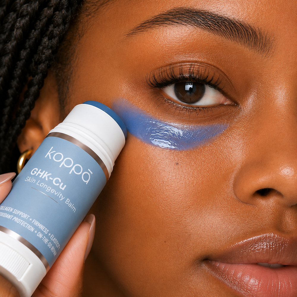 Woman applying Koppā GHK-Cu stick under her eye — copper peptides skincare