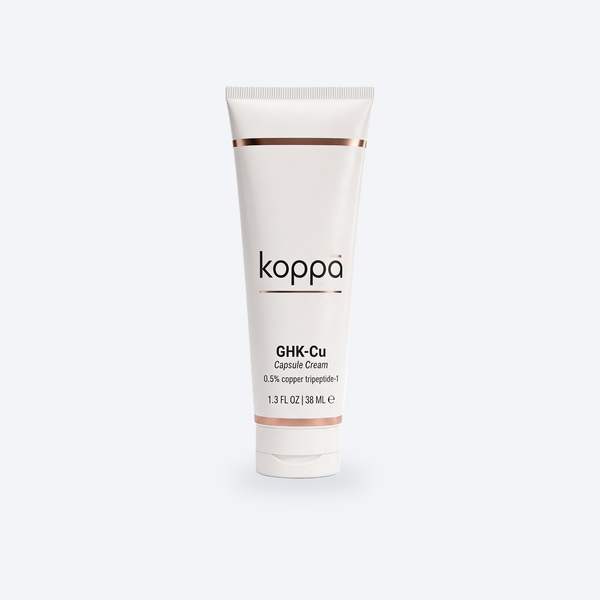 Koppā GHK-Cu Capsule Cream tube on a soft porcelain background — Koppā GHK-Cu copper peptide skincare