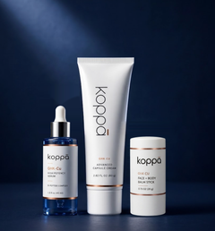 The Koppā GHK-Cu Protocol: copper peptide serum, capsule cream and balm stick together on a dark navy background