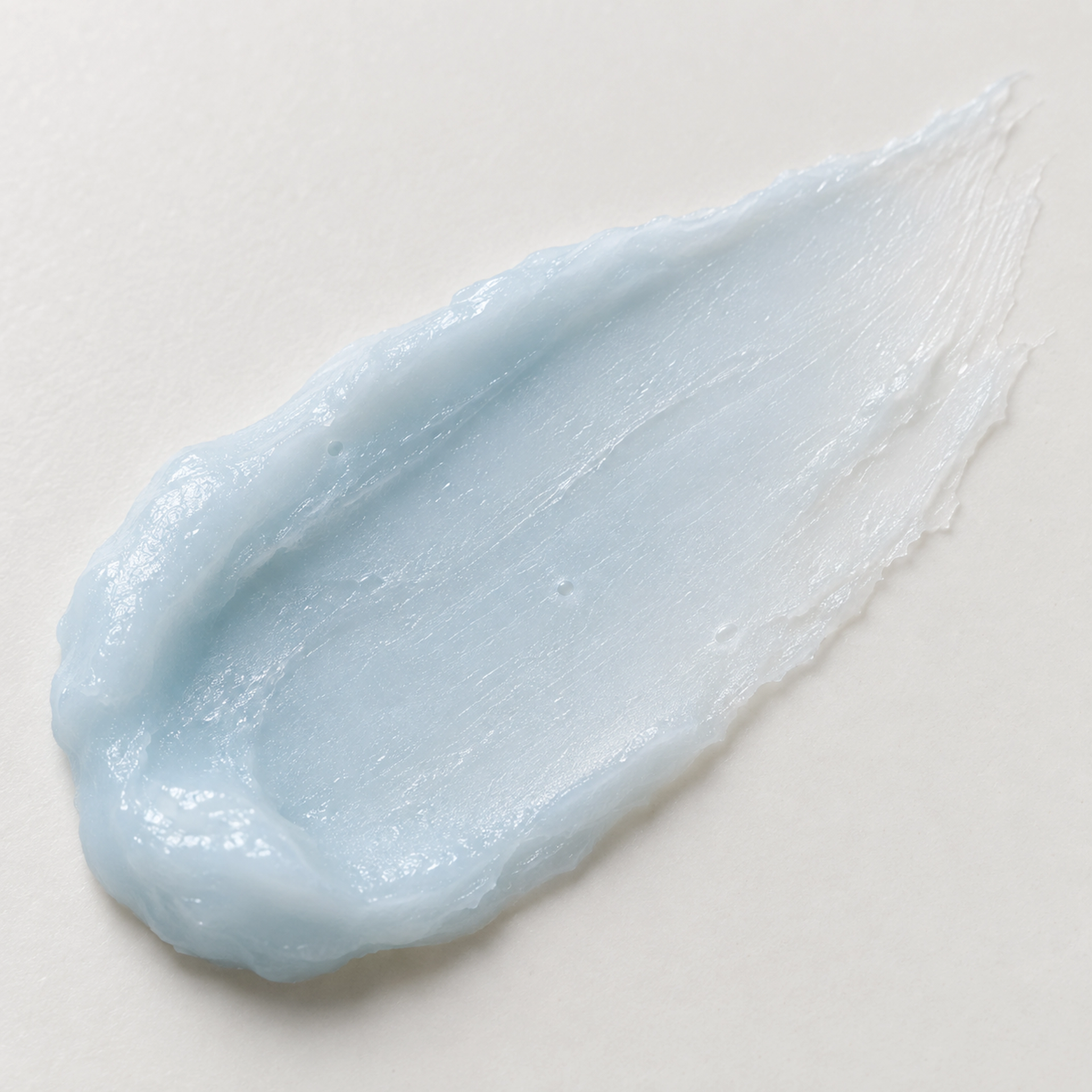 Macro close-up of a pale blue Koppā balm swatch with natural texture