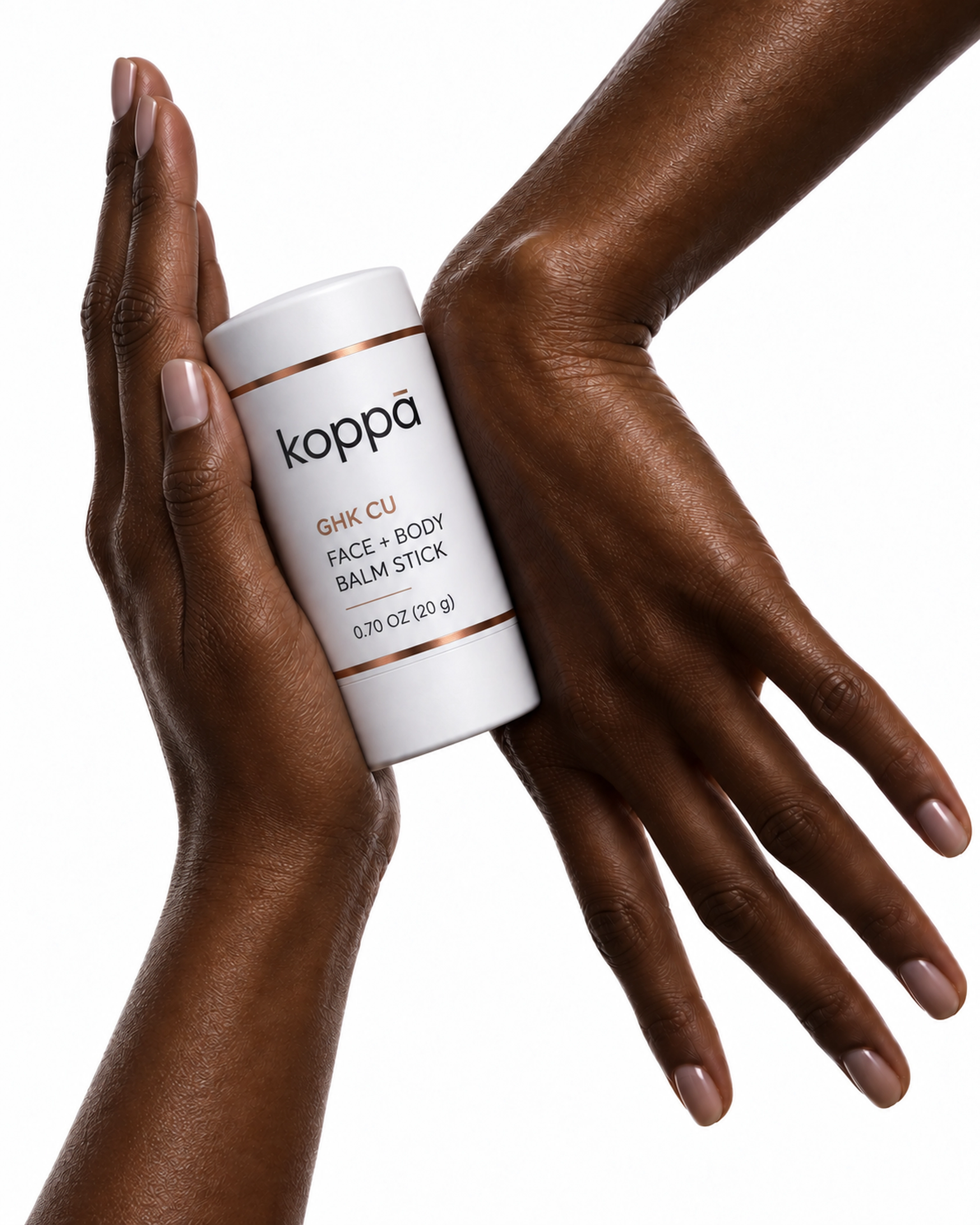 Koppā balm stick balanced between the sides of two hands