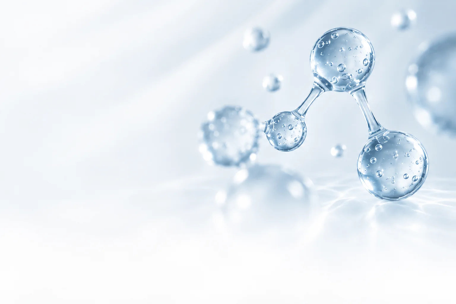 Illustrative molecule rendered in clear icy-blue glass